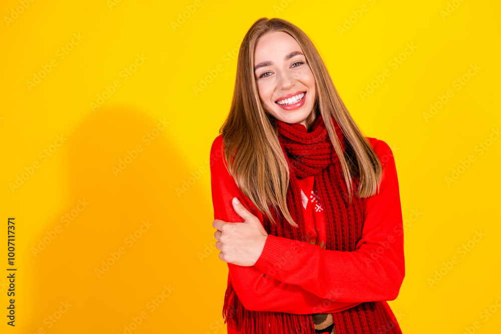 Portrait of nice young girl hug shoulders empty space wear festive new year sweater isolated on yellow color background Portrait of nice young girl hug shoulders empty space wear festive new year sweater isolated on yellow color background