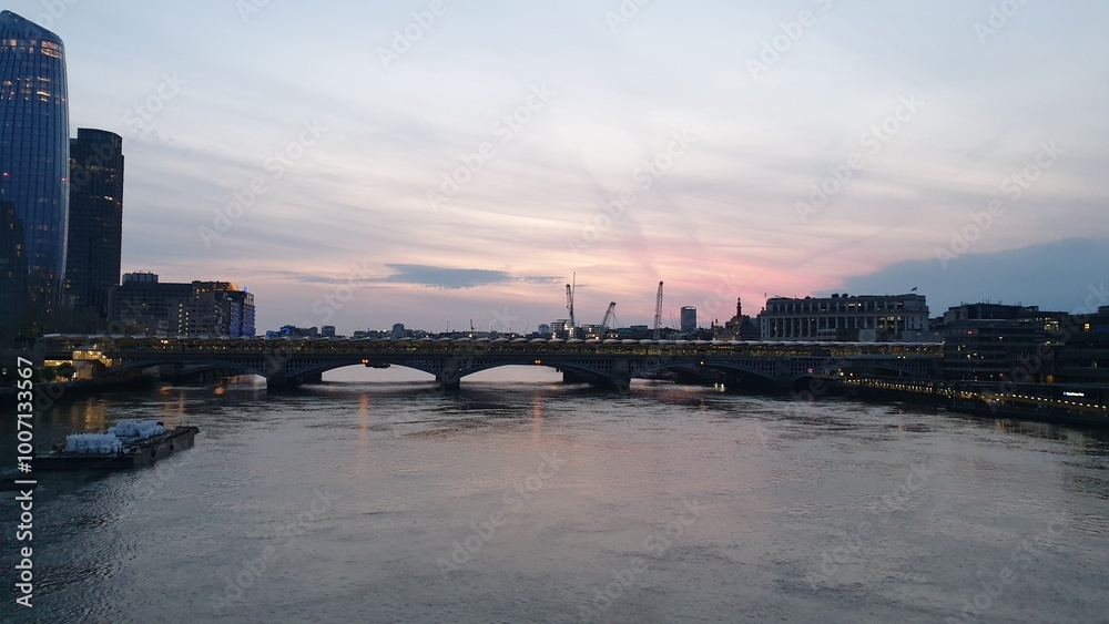 View of Southwark Bridge over the River Thames at sunset in London View of Southwark Bridge over the River Thames at sunset in London