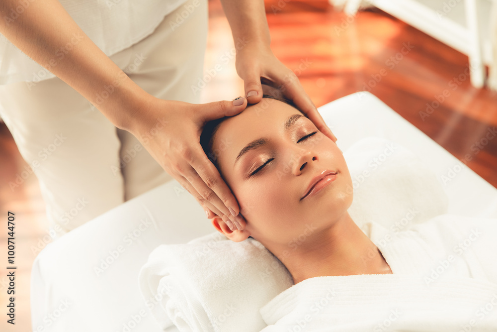 Caucasian woman enjoying relaxing anti-stress head massage and pampering facial beauty skin recreation leisure in dayspa modern light ambient at luxury resort or hotel spa salon. Quiescent Caucasian woman enjoying relaxing anti-stress head massage and pampering facial beauty skin recreation leisure in dayspa modern light ambient at luxury resort or hotel spa salon. Quiescent