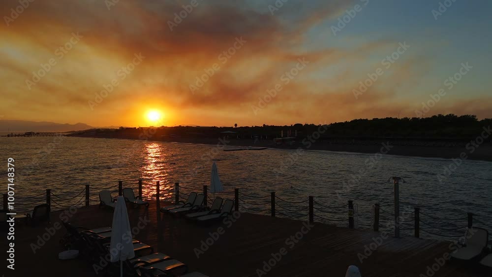Drone Departure from Pier at Dusk, Capturing an Orange Sunset Over the Sea Drone Departure from Pier at Dusk, Capturing an Orange Sunset Over the Sea