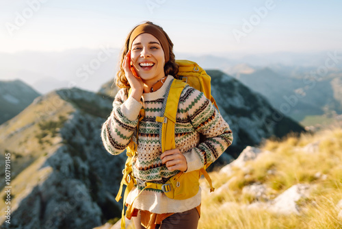 Tableau sur toile Woman tourist standing at mountains with backpack admiring landscape