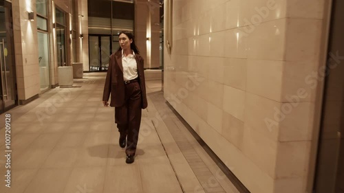 Wallpaper Mural Young ethnic woman walking in yard of buildings Torontodigital.ca