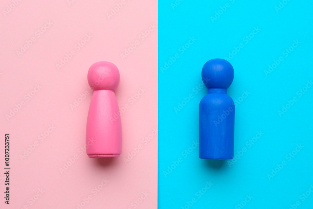 Gender equality concept. Male and female figures on color background, flat lay Gender equality concept. Male and female figures on color background, flat lay