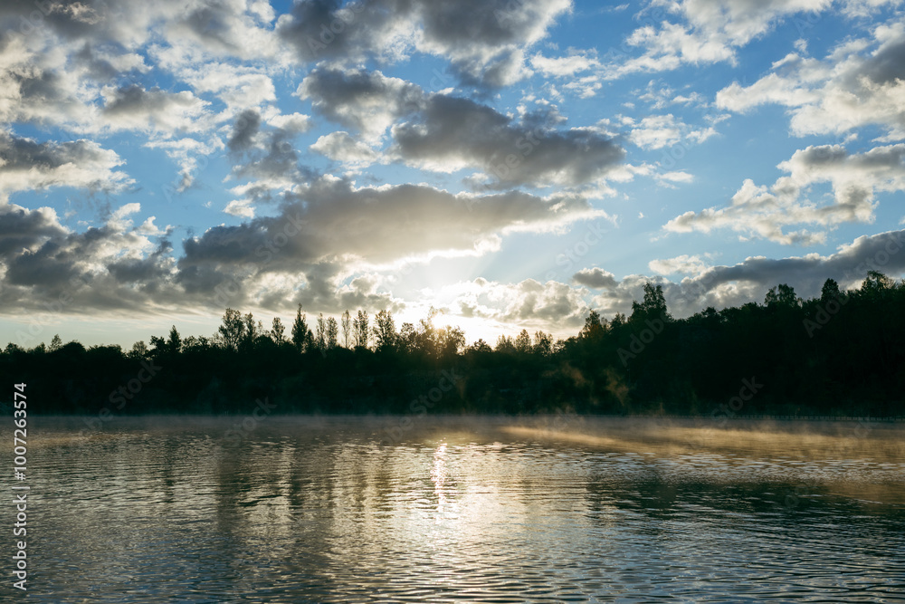 Misty sunrise over a lake. A foggy morning on autumn by a small lake. Misty reflection in water. Dreamy wanderlust, web banner