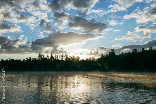Misty sunrise over a lake. A foggy morning on autumn by a small lake. Misty reflection in water. Dreamy wanderlust, web banner