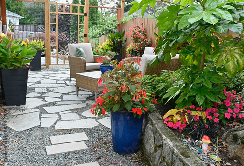Fototapeta Naklejka Na Ścianę i Meble -  Outdoor tropical terraced patio in backyard garden for casual outdoor seating