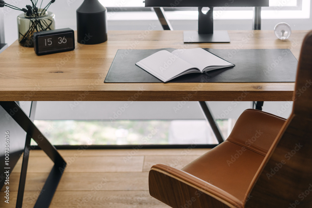 Modern workspace setup with an open notebook on a wooden desk in a bright office environment Modern workspace setup with an open notebook on a wooden desk in a bright office environment