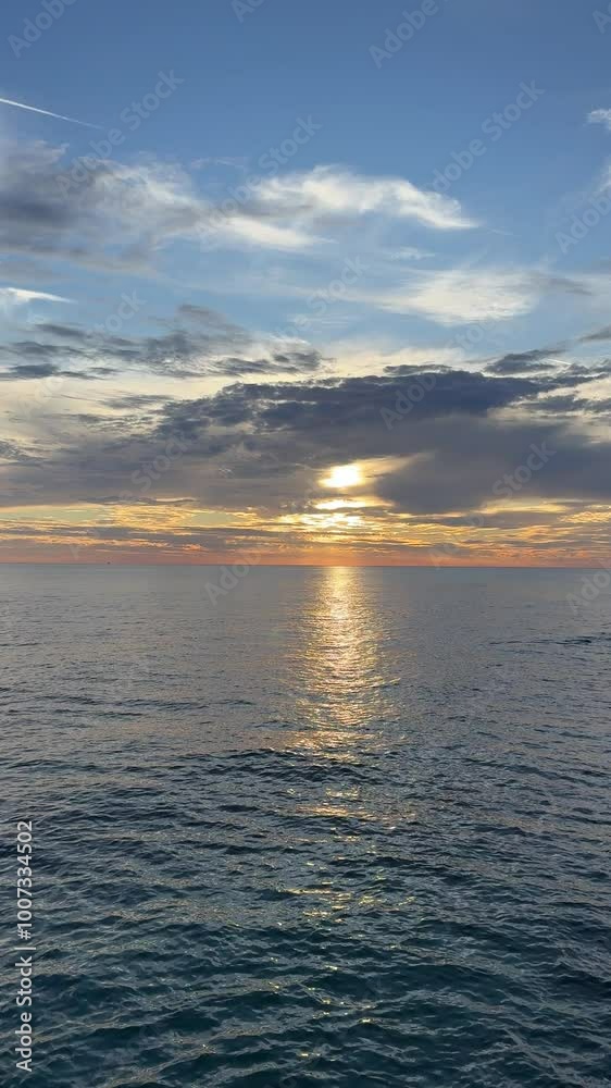 Stunning sunset and calm shiny sea, vertical video. Stunning sunset and calm shiny sea, vertical video.
