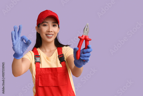 Young female electrician wi...