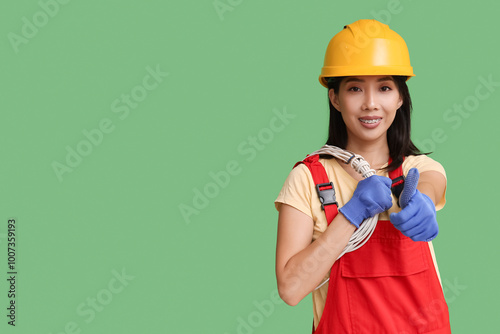 Young female electrician wi...