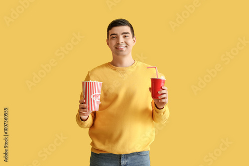 Happy young man with popcor...