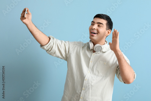 Happy young man with mobile...