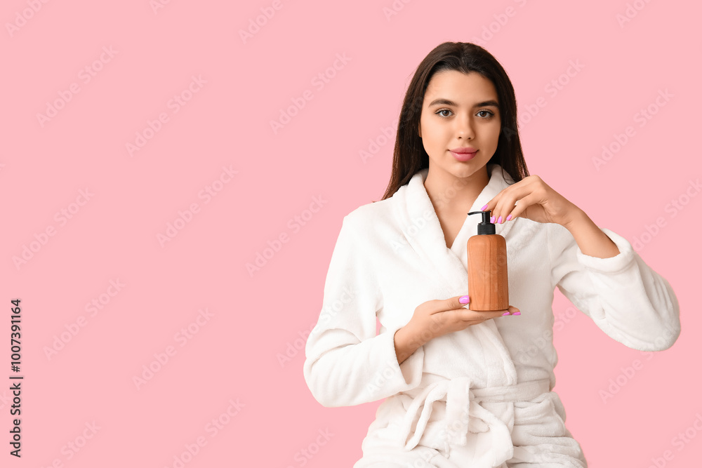 Beautiful young woman holding bottle of cosmetic product on pink background Beautiful young woman holding bottle of cosmetic product on pink background