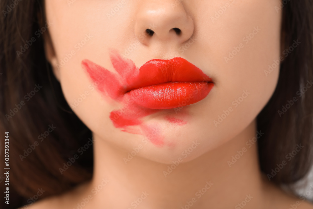 Beautiful young woman with smeared red lipstick, closeup Beautiful young woman with smeared red lipstick, closeup