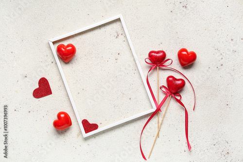 Composition with frame nd different hearts for Valentine's Day on light background photo