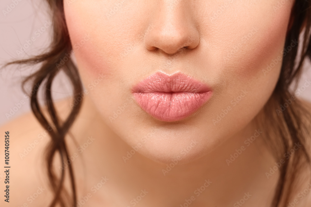 Beautiful young woman blowing kiss on color background, closeup Beautiful young woman blowing kiss on color background, closeup