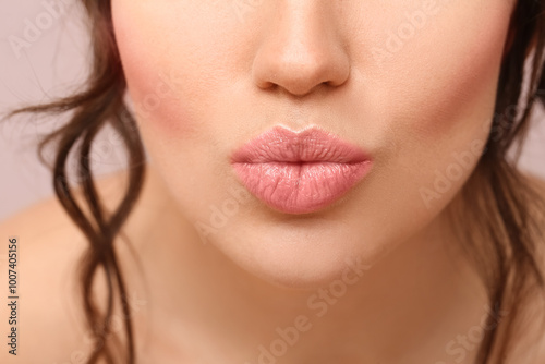 Beautiful young woman blowi...