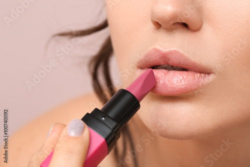Woman applying beautiful li...