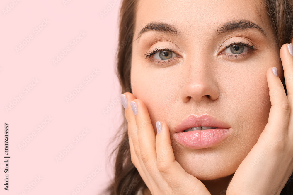 Beautiful young woman with natural makeup on pink background, closeup