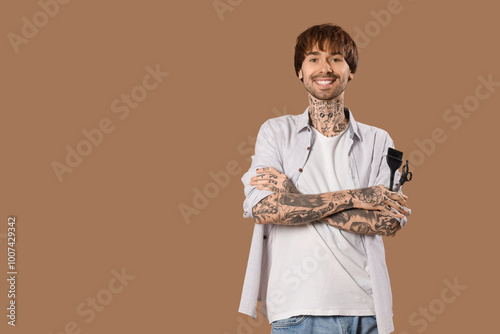 Young tattooed barber with ...