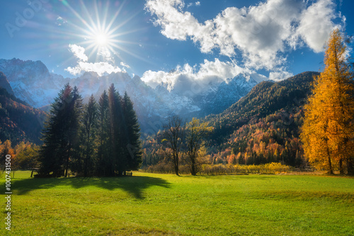 Konstfotografi Alpine mountain valley at sunset in golden autumn