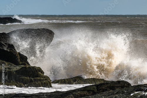 Large ocean wave crashing over rocks
