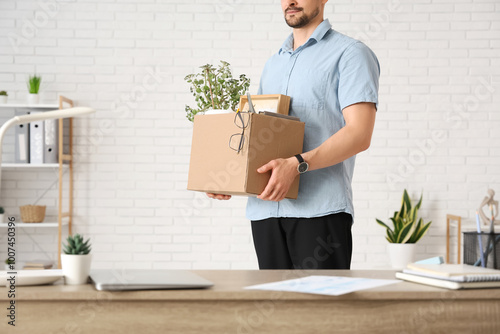 Fired young man holding box...