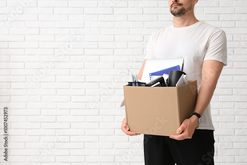 Fired young man holding box...