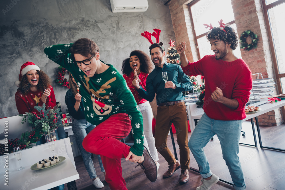 Fototapeta premium Portrait of company office workers have fun dancing drink champagne new year time loft office indoors
