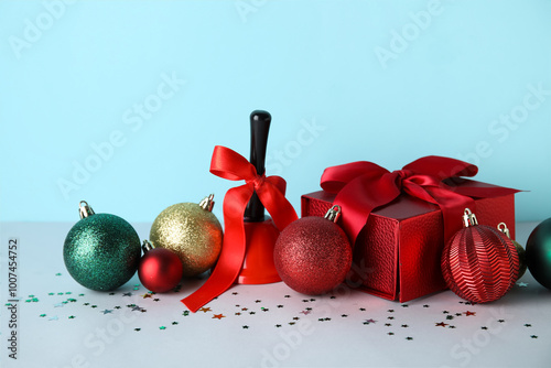 Christmas gift, jingle bell and decorations on blue background photo