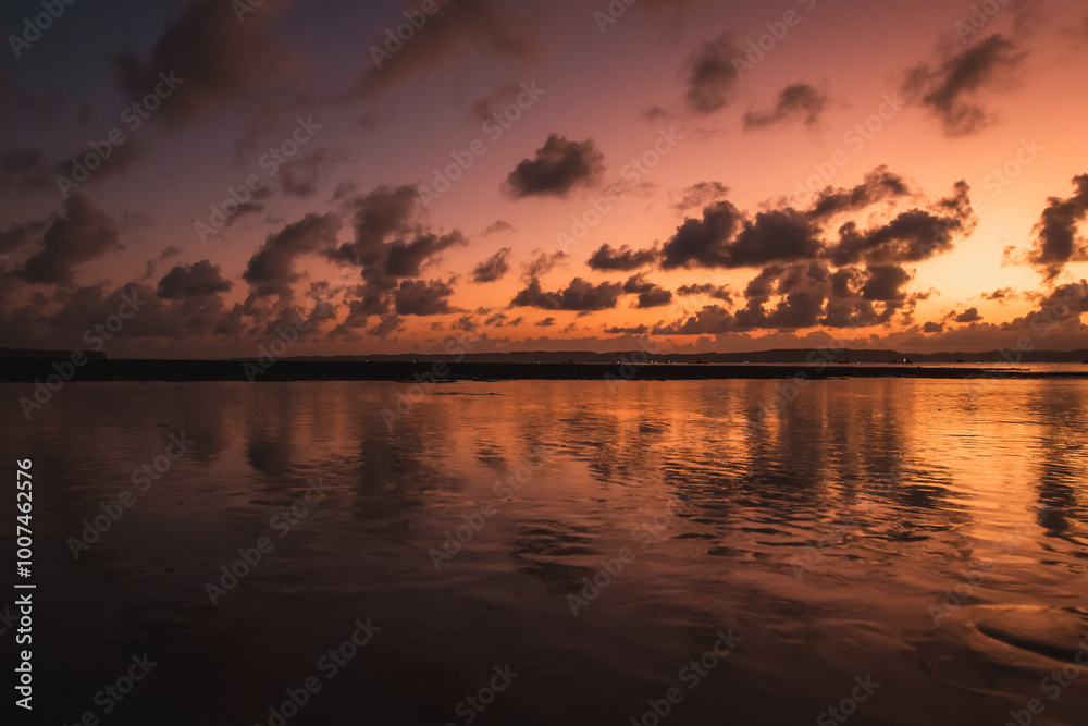 A sunset by the calm sea. A sunset by the calm sea.