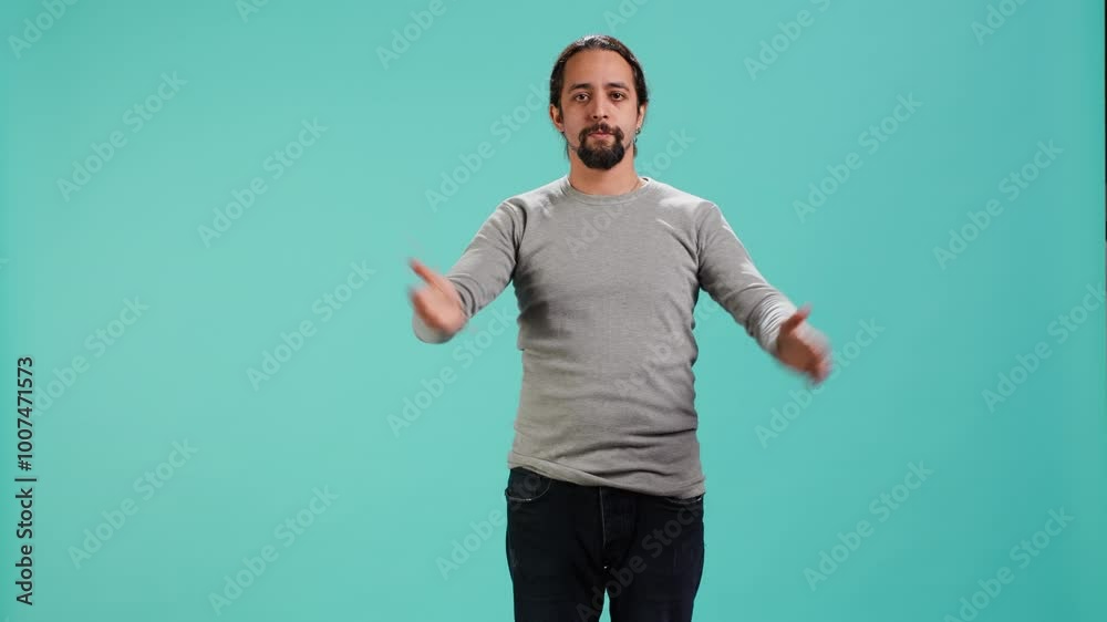 Man wearing casual clothing covering eyes, ears and mouth, imitating three wise monkeys, doing dont see, dont hear and dont speak hand gesturing concept, blue studio backdrop, camera A Man wearing casual clothing covering eyes, ears and mouth, imitating three wise monkeys, doing dont see, dont hear and dont speak hand gesturing concept, blue studio backdrop, camera A