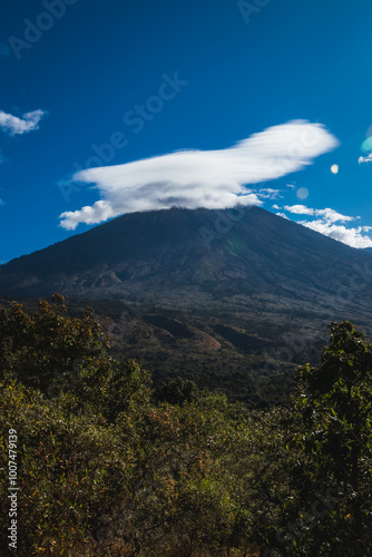 A large volcano with clouds covering the top