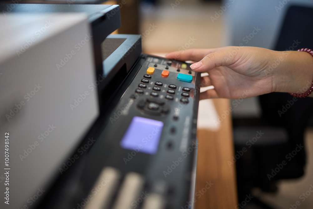 A Detailed Close Up of a Media Control Device Being Actively Used in a Creative Workspace