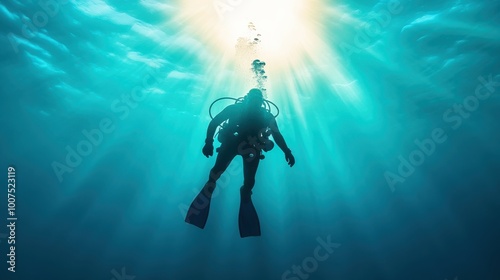 Wallpaper Mural A silhouetted scuba diver moves gracefully beneath the water's surface, where rays of sunlight penetrate, creating a captivating and mystical underwater scene. Torontodigital.ca