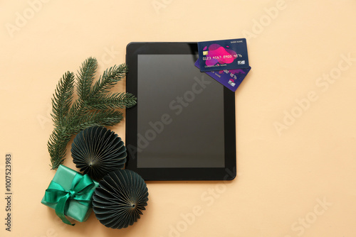 Composition with tablet computer, credit cards and Christmas decorations on c...