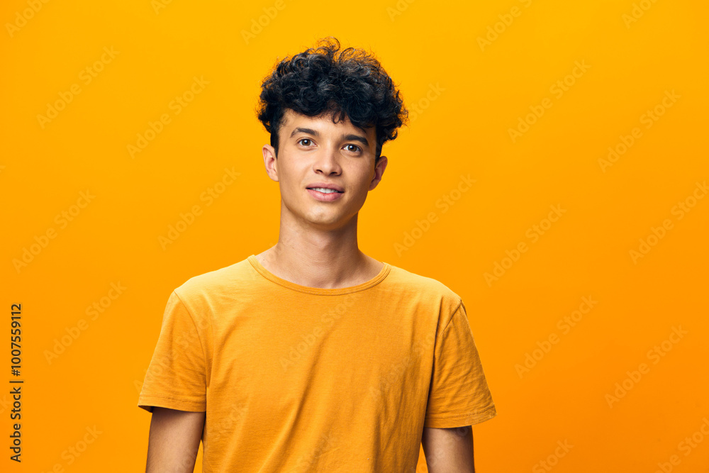 Young man in a bright yellow shirt smiling against an orange background, showcasing confidence and positivity in contemporary fashion photography Emphasizing youthfulness and vibrancy Young man in a bright yellow shirt smiling against an orange background, showcasing confidence and positivity in contemporary fashion photography Emphasizing youthfulness and vibrancy