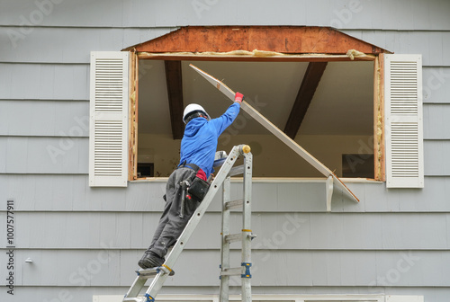 contractor working on replacing the window of the house photo