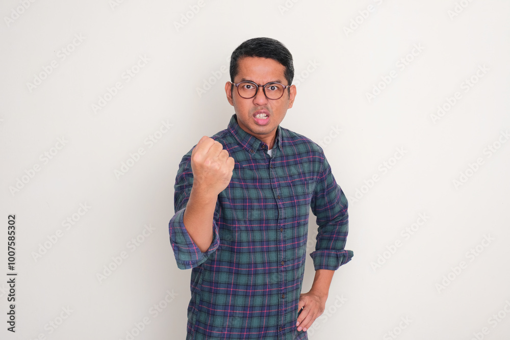 A man doing punching gesture showing angry expression