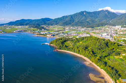 Aerial view of the blue sea with a village near Sacheon-si, South Korea