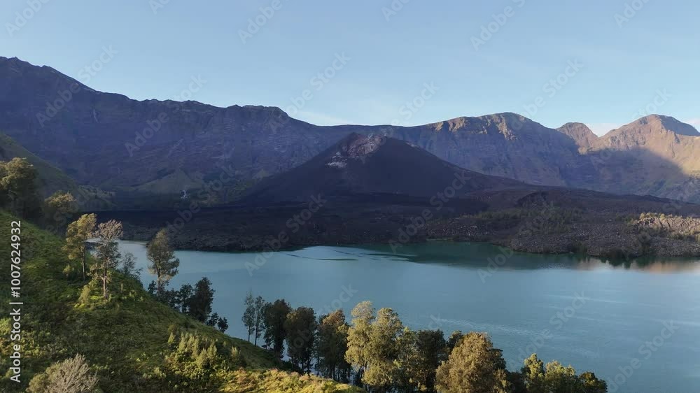 The beauty of a volcano located in the middle of a beautiful lake with the edge of an exotic tropical forest. A natural scene recorded using a drone The beauty of a volcano located in the middle of a beautiful lake with the edge of an exotic tropical forest. A natural scene recorded using a drone