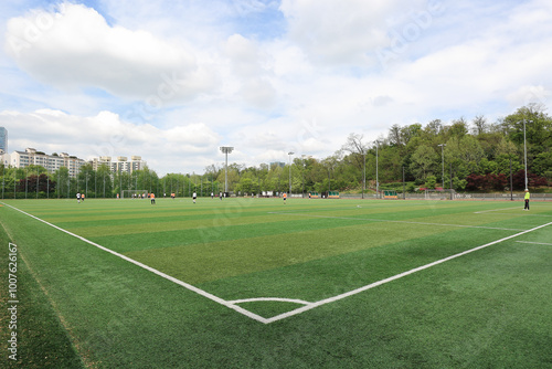 Yeongheung Park, Suwon-si, Gyeonggi-do, South Korea - May 3, 2020: People playing soccer at the artificial turf field