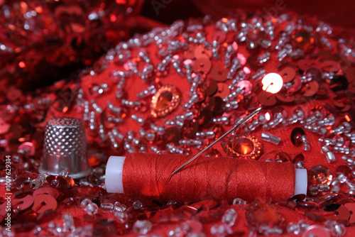 Red Beaded Fabric With Spool of Thread and Thimble
