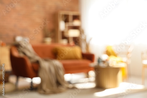 Blurred view of living room with red sofa, armchair and pumpkins photo