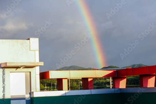 rainbow over buildings in the countryside photo