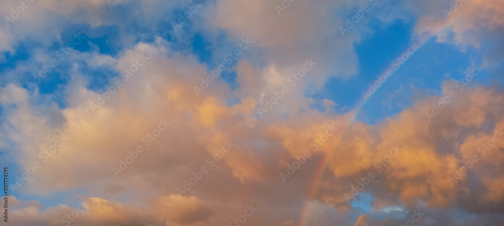 Pastel colored clouds and rainbow in sunset sky. Amazing sky landscape. The sky that gives calmness, happiness and peace. Pastel colored clouds and rainbow in sunset sky. Amazing sky landscape. The sky that gives calmness, happiness and peace.