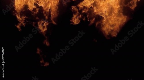 Realistic moving fire on black photo