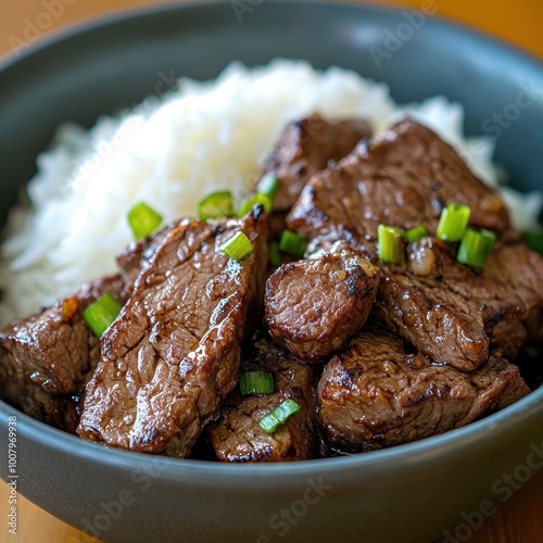 Marinated Beef Bistek on Rice Bowl with Garnish photo