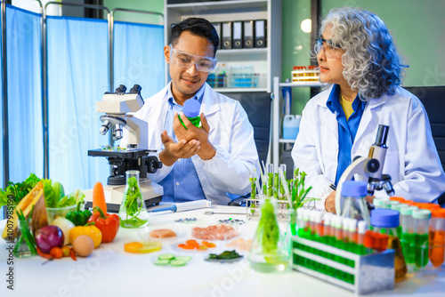 A reliable middle-aged Asian male researcher collaborates with experienced gray-haired elderly Asian female nutritionist in laboratory, food ingredients, extracts, their impact on nutrition health.