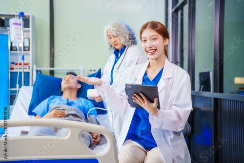 A middle-aged man lies bedridden on hospital bed, closely monitored by an old Asian woman doctor and young nurse. They assess his symptoms, including heart and lung conditions, offer advice.
